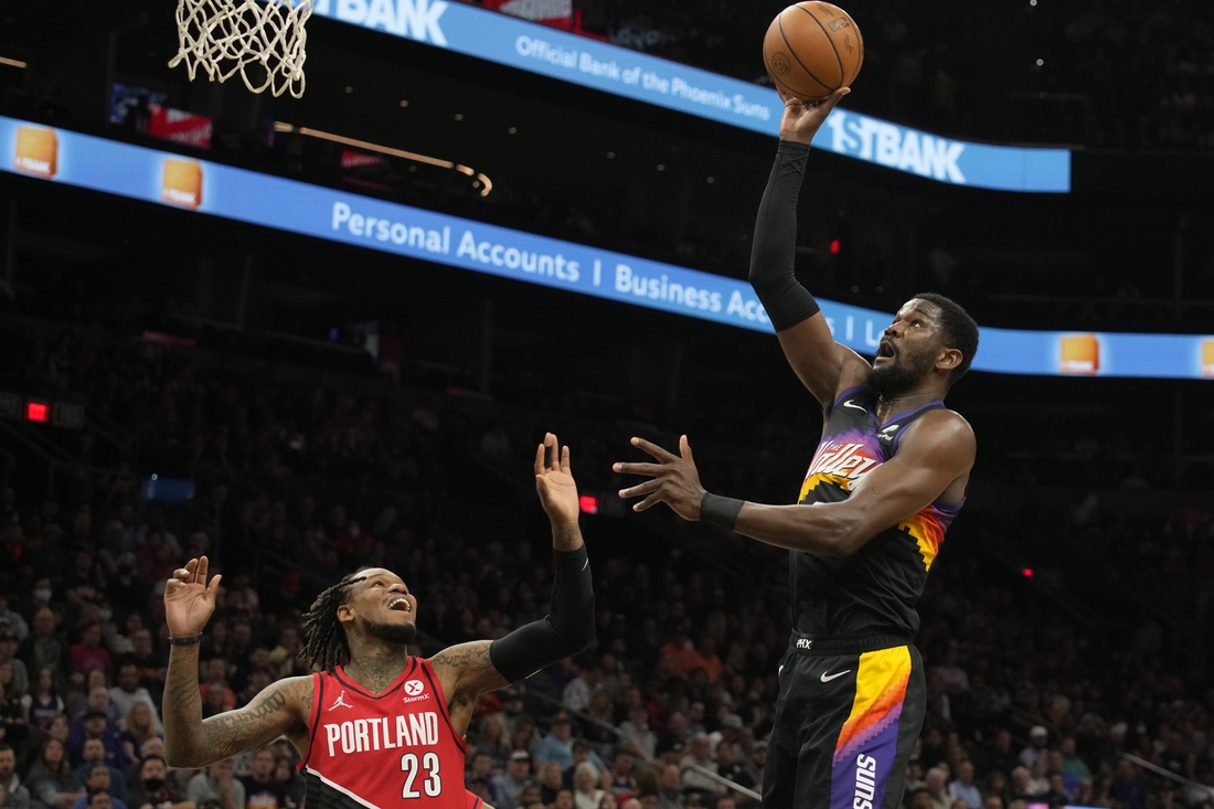 Mar 2, 2022; Phoenix, Arizona, USA; Phoenix Suns center Deandre Ayton (22) shoots the ball over Portland Trail Blazers guard Ben McLemore (23) in the first half at Footprint Center. Mandatory Credit: Rick Scuteri-USA TODAY Sports