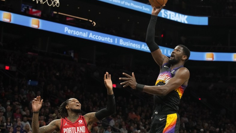 Mar 2, 2022; Phoenix, Arizona, USA; Phoenix Suns center Deandre Ayton (22) shoots the ball over Portland Trail Blazers guard Ben McLemore (23) in the first half at Footprint Center. Mandatory Credit: Rick Scuteri-USA TODAY Sports