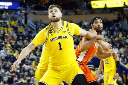 Feb 27, 2022; Ann Arbor, Michigan, USA;  Michigan Wolverines center Hunter Dickinson (1) and Illinois Fighting Illini guard Jacob Grandison (3) looks for the rebound at Crisler Center. Mandatory Credit: Rick Osentoski-USA TODAY Sports