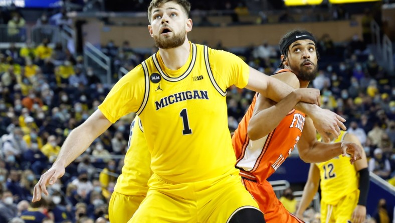 Feb 27, 2022; Ann Arbor, Michigan, USA;  Michigan Wolverines center Hunter Dickinson (1) and Illinois Fighting Illini guard Jacob Grandison (3) looks for the rebound at Crisler Center. Mandatory Credit: Rick Osentoski-USA TODAY Sports