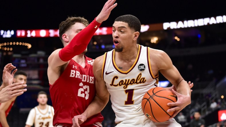 Mar 4, 2022; St. Louis, MO, USA;  Loyola Ramblers guard Lucas Williamson (1) drives to the basket as Bradley Braves guard Ville Tahvanainen (23) defends during the first half in the quarterfinals round of the Missouri Valley Conference Tournament at Enterprise Center. Mandatory Credit: Jeff Curry-USA TODAY Sports