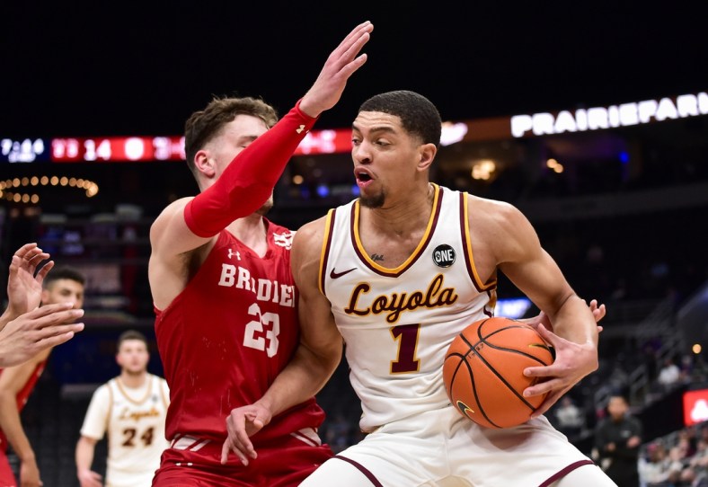 Mar 4, 2022; St. Louis, MO, USA;  Loyola Ramblers guard Lucas Williamson (1) drives to the basket as Bradley Braves guard Ville Tahvanainen (23) defends during the first half in the quarterfinals round of the Missouri Valley Conference Tournament at Enterprise Center. Mandatory Credit: Jeff Curry-USA TODAY Sports