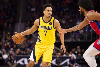 Mar 4, 2022; Detroit, Michigan, USA; Indiana Pacers guard Malcolm Brogdon (7) gets defended by Detroit Pistons forward Marvin Bagley III (35) during the second quarter at Little Caesars Arena. Mandatory Credit: Raj Mehta-USA TODAY Sports