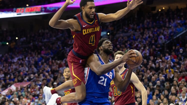 Mar 4, 2022; Philadelphia, Pennsylvania, USA; Philadelphia 76ers center Joel Embiid (21) is fouled by Cleveland Cavaliers center Evan Mobley (4) while driving to the basket in the fourth quarter at Wells Fargo Center. Mandatory Credit: Bill Streicher-USA TODAY Sports