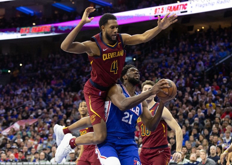 Mar 4, 2022; Philadelphia, Pennsylvania, USA; Philadelphia 76ers center Joel Embiid (21) is fouled by Cleveland Cavaliers center Evan Mobley (4) while driving to the basket in the fourth quarter at Wells Fargo Center. Mandatory Credit: Bill Streicher-USA TODAY Sports