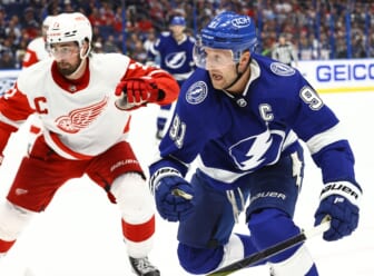 Mar 4, 2022; Tampa, Florida, USA; Tampa Bay Lightning center Steven Stamkos (91) and Detroit Red Wings center Dylan Larkin (71) skate after the puck during the third period at Amalie Arena. Mandatory Credit: Kim Klement-USA TODAY Sports