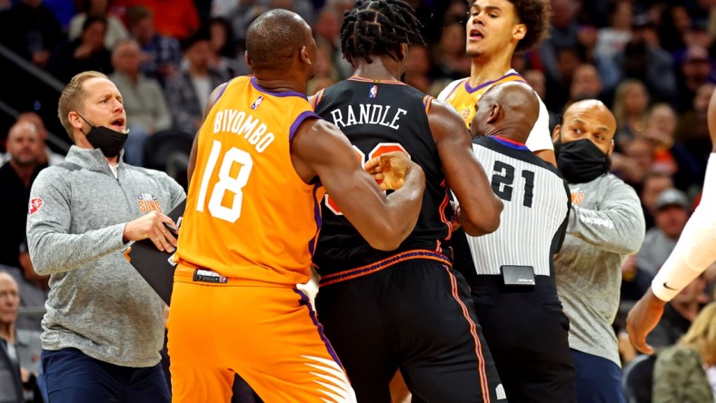 Mar 4, 2022; Phoenix, Arizona, USA; Phoenix Suns forward Cameron Johnson (23) and New York Knicks forward Julius Randle (30) have to be broken up during the second half at Footprint Center. Mandatory Credit: Mark J. Rebilas-USA TODAY Sports