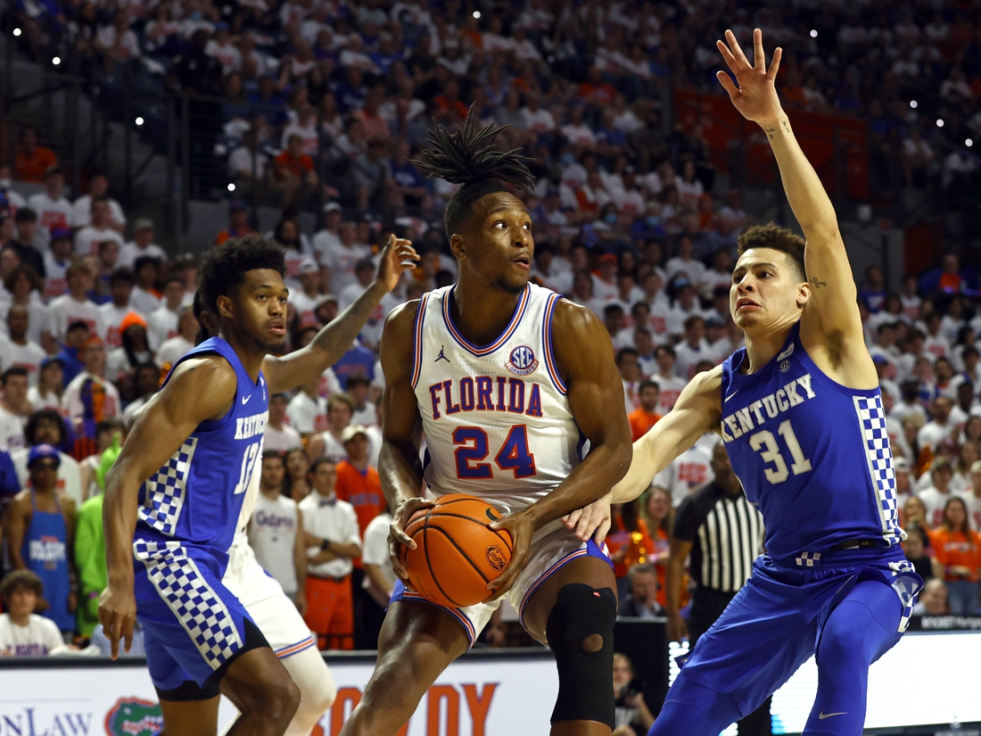 Mar 5, 2022; Gainesville, Florida, USA; Florida Gators guard Phlandrous Fleming Jr. (24) drives to the basket as Kentucky Wildcats forward Keion Brooks Jr. (12) and guard Kellan Grady (31) defend during the first half at Billy Donovan Court at Exactech Arena. Mandatory Credit: Kim Klement-USA TODAY Sports