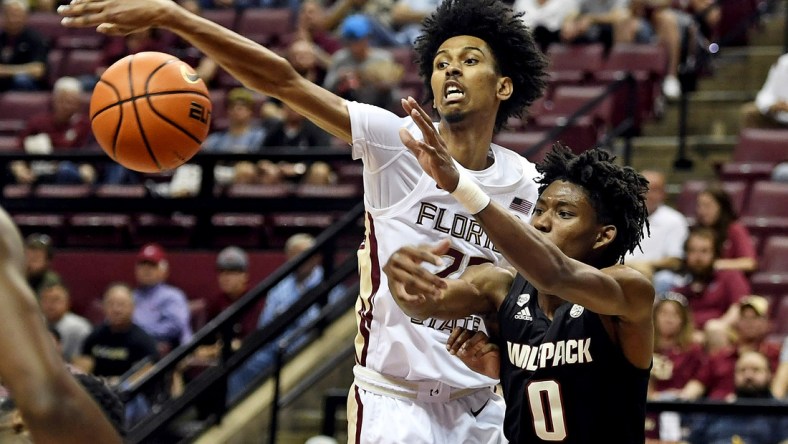 Mar 5, 2022; Tallahassee, Florida, USA; Florida State Seminoles forward John Butler (22) fights for a loose ball with North Carolina State Wolfpack guard Terquavion Smith (0) during the first half at Donald L. Tucker Center. Mandatory Credit: Melina Myers-USA TODAY Sports