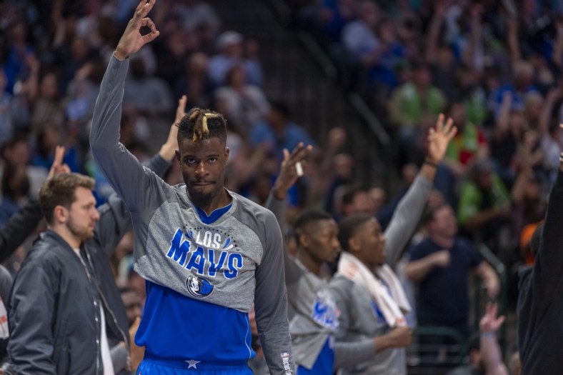 Mar 5, 2022; Dallas, Texas, USA; Dallas Mavericks forward Reggie Bullock (25) celebrates on the team bench during the second half against the Sacramento Kings at the American Airlines Center. Mandatory Credit: Jerome Miron-USA TODAY Sports