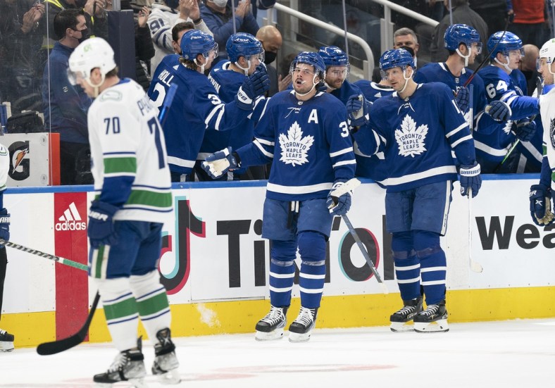 Mar 5, 2022; Toronto, Ontario, CAN; Toronto Maple Leafs center Auston Matthews (34) celebrates at the bench after scoring a goal during the second period against the Vancouver Canucks at Scotiabank Arena. Mandatory Credit: Nick Turchiaro-USA TODAY Sports