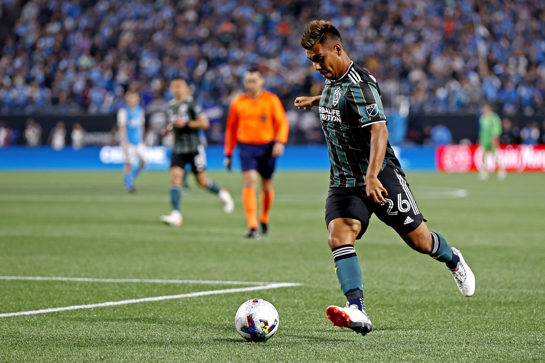 Mar 5, 2022; Charlotte, North Carolina, USA; Los Angeles Galaxy midfielder Efrain Alvarez (26) shoots the ball against Charlotte FC at Bank of America Stadium. Mandatory Credit: Nell Redmond-USA TODAY Sports