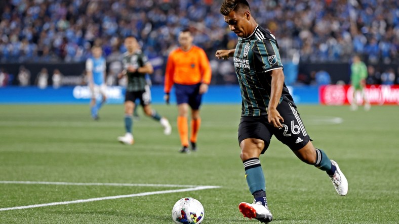 Mar 5, 2022; Charlotte, North Carolina, USA; Los Angeles Galaxy midfielder Efrain Alvarez (26) shoots the ball against Charlotte FC at Bank of America Stadium. Mandatory Credit: Nell Redmond-USA TODAY Sports