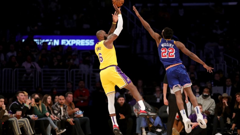 Mar 5, 2022; Los Angeles, California, USA; Los Angeles Lakers forward LeBron James (6) shoots a ball over Golden State Warriors forward Andrew Wiggins (22) during the first quarter at Crypto.com Arena. Mandatory Credit: Kiyoshi Mio-USA TODAY Sports