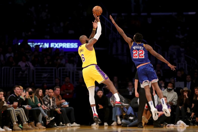 Mar 5, 2022; Los Angeles, California, USA; Los Angeles Lakers forward LeBron James (6) shoots a ball over Golden State Warriors forward Andrew Wiggins (22) during the first quarter at Crypto.com Arena. Mandatory Credit: Kiyoshi Mio-USA TODAY Sports
