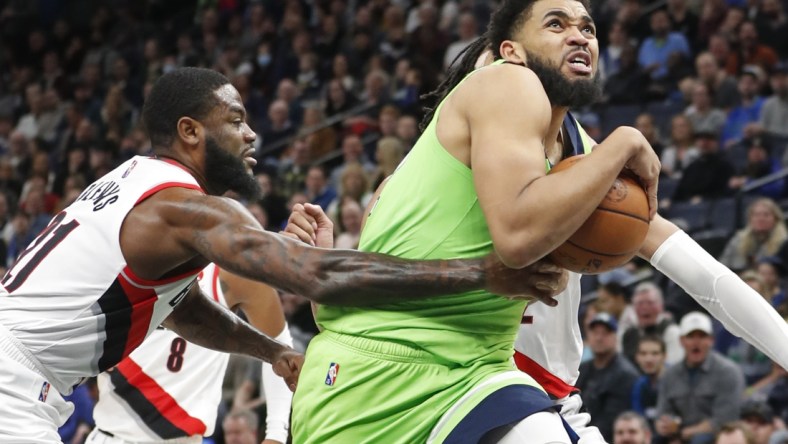 Mar 5, 2022; Minneapolis, Minnesota, USA; Minnesota Timberwolves center Karl-Anthony Towns (32) pulls away from Portland Trail Blazers guard Keljin Blevins (21) and goes to the basket in the fourth quarter at Target Center. Mandatory Credit: Bruce Kluckhohn-USA TODAY Sports