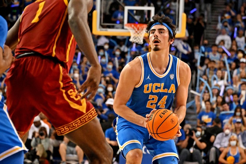 Mar 5, 2022; Los Angeles, California, USA; UCLA Bruins guard Jaime Jaquez Jr. (24) shoots the ball against USC Trojans forward Chevez Goodwin (1) during the second half at Pauley Pavilion presented by Wescom. Mandatory Credit: Richard Mackson-USA TODAY Sports
