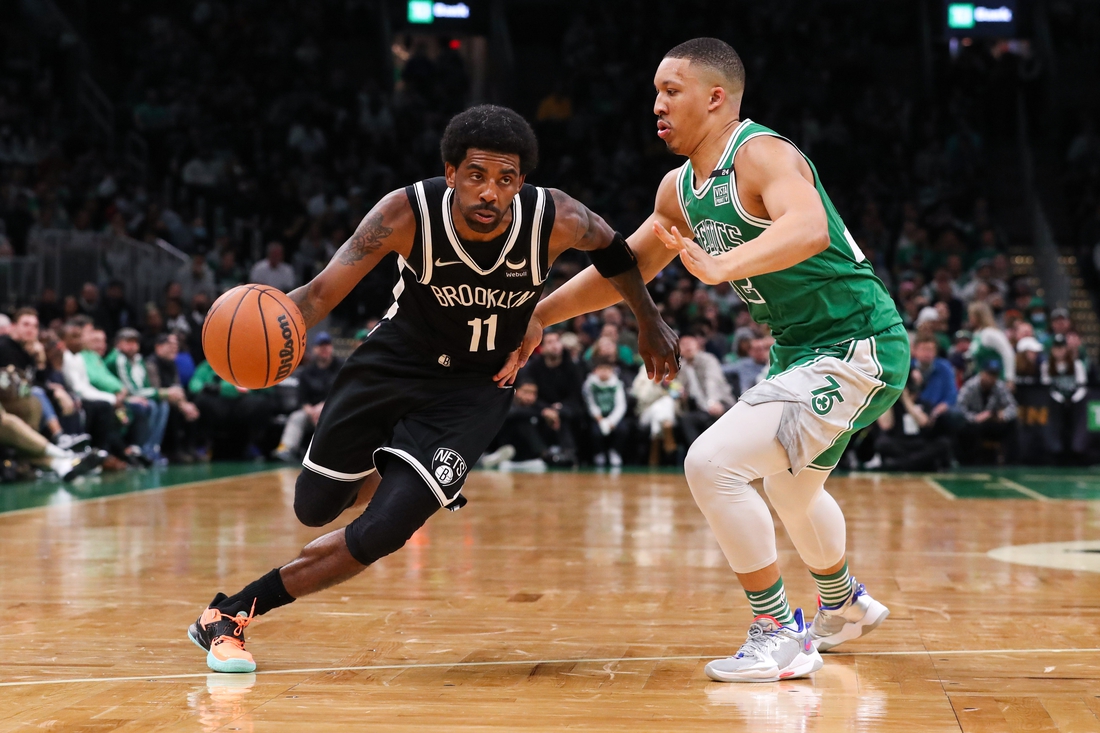 Mar 6, 2022; Boston, Massachusetts, USA; Brooklyn Nets guard Kyrie Irving (11) drives to the basket during the first half against the Boston Celtics at TD Garden. Mandatory Credit: Paul Rutherford-USA TODAY Sports