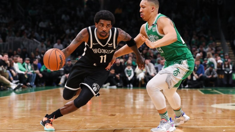 Mar 6, 2022; Boston, Massachusetts, USA; Brooklyn Nets guard Kyrie Irving (11) drives to the basket during the first half against the Boston Celtics at TD Garden. Mandatory Credit: Paul Rutherford-USA TODAY Sports