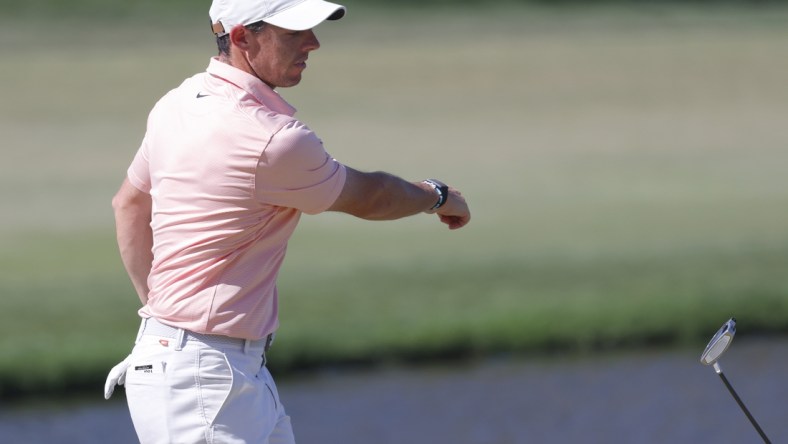 Mar 6, 2022; Orlando, Florida, USA; Rory McIlroy throws his putter toward the lake after missing a putt on the eighth green during the final round of the Arnold Palmer Invitational golf tournament. Mandatory Credit: Reinhold Matay-USA TODAY Sports