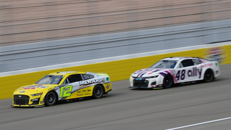 Mar 6, 2022; Las Vegas, Nevada, USA; NASCAR Cup Series driver Ryan Blaney (12) drives ahead of driver Alex Bowman (48) during the Pennzoil 400 at Las Vegas Motor Speedway. Mandatory Credit: Gary A. Vasquez-USA TODAY Sports