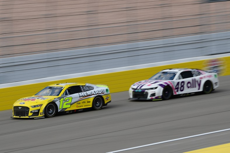 Mar 6, 2022; Las Vegas, Nevada, USA; NASCAR Cup Series driver Ryan Blaney (12) drives ahead of driver Alex Bowman (48) during the Pennzoil 400 at Las Vegas Motor Speedway. Mandatory Credit: Gary A. Vasquez-USA TODAY Sports