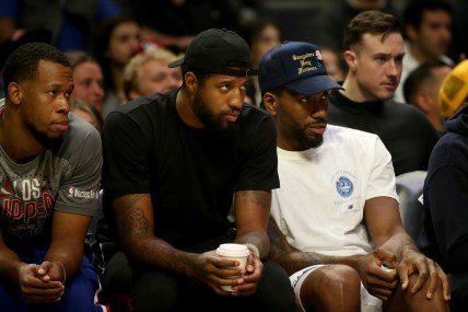 Mar 6, 2022; Los Angeles, California, USA; Los Angeles Clippers guard Paul George and forward Kawhi Leonard watch a game against the New York Knicks during the first half at Crypto.com Arena. The Knicks won 116-93. Mandatory Credit: Kiyoshi Mio-USA TODAY Sports