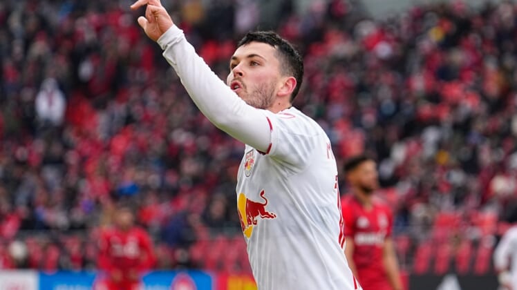 Mar 5, 2022; Toronto, Ontario, CAN; New York Red Bulls midfielder Lewis Morgan (10) signals three goals to the Toronto FC fans after scoring a hat trick in the first half at BMO Field. Mandatory Credit: John E. Sokolowski-USA TODAY Sports