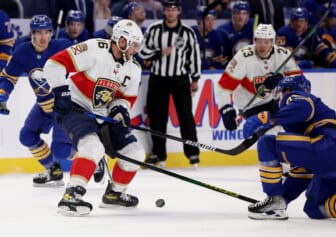 Mar 7, 2022; Buffalo, New York, USA;  Florida Panthers center Aleksander Barkov (16) looks to control the puck as Buffalo Sabres left wing Victor Olofsson (71) tries to defend during the first period at KeyBank Center. Mandatory Credit: Timothy T. Ludwig-USA TODAY Sports