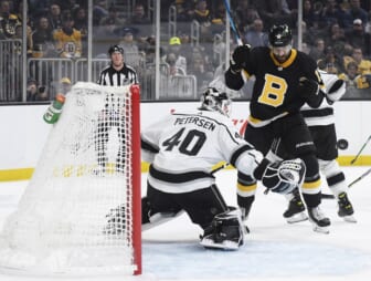 Mar 7, 2022; Boston, Massachusetts, USA;  Boston Bruins left wing Nick Foligno (17) eyes the puck as it goes past Los Angeles Kings goaltender Cal Petersen (40) during the first period at TD Garden. Mandatory Credit: Bob DeChiara-USA TODAY Sports