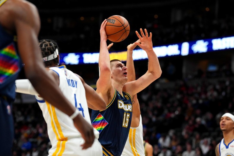 Mar 7, 2022; Denver, Colorado, USA; Denver Nuggets center Nikola Jokic (15) shoots the ball in the first quarter against the Golden State Warriors at Ball Arena. Mandatory Credit: Ron Chenoy-USA TODAY Sports