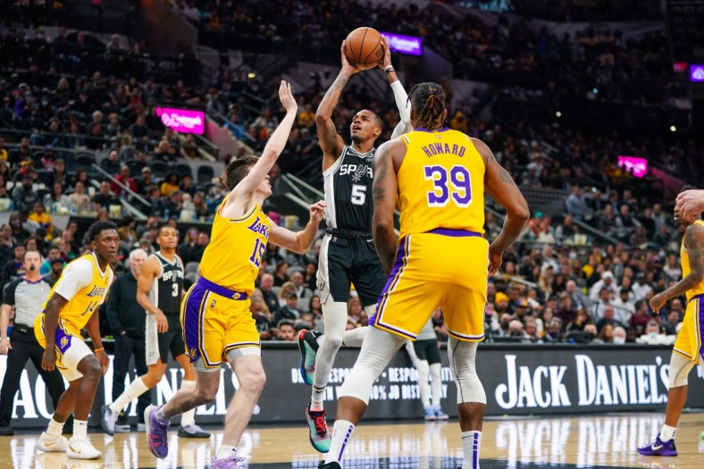 Mar 7, 2022; San Antonio, Texas, USA;  San Antonio Spurs guard Dejounte Murray (5) shoots over Los Angeles Lakers guard Austin Reaves (15) in the first half at the AT&T Center. Mandatory Credit: Daniel Dunn-USA TODAY Sports