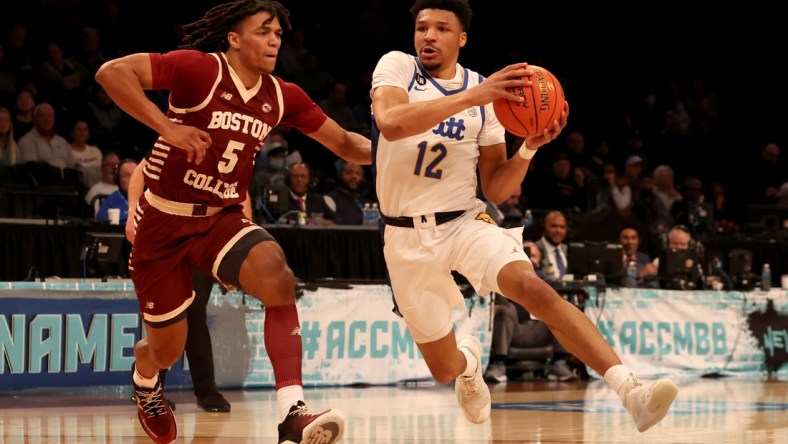 Mar 8, 2022; Brooklyn, NY, USA; Pittsburgh Panthers guard Ithiel Horton (12) drives to the basket against Boston College Eagles guard DeMarr Langford Jr. (5) during the first half at Barclays Center. Mandatory Credit: Brad Penner-USA TODAY Sports