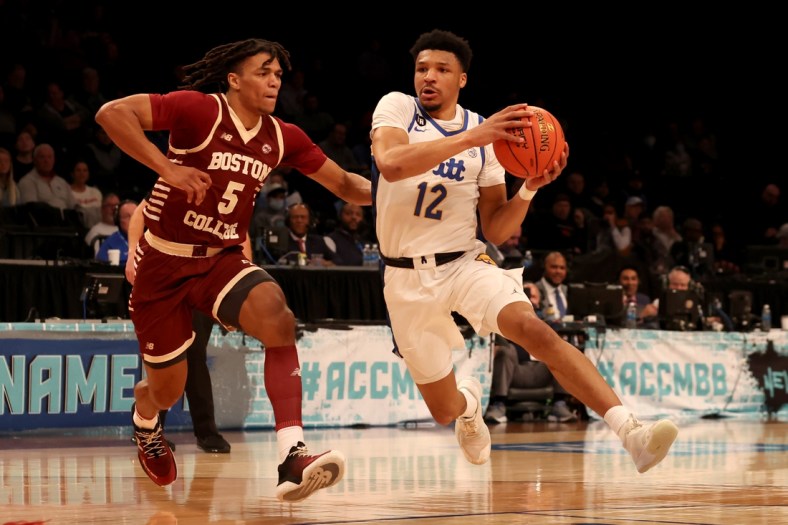 Mar 8, 2022; Brooklyn, NY, USA; Pittsburgh Panthers guard Ithiel Horton (12) drives to the basket against Boston College Eagles guard DeMarr Langford Jr. (5) during the first half at Barclays Center. Mandatory Credit: Brad Penner-USA TODAY Sports