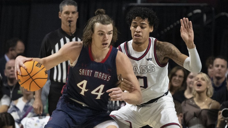 March 8, 2022; Las Vegas, NV, USA; Saint Mary's Gaels guard Alex Ducas (44) dribbles the basketball against Gonzaga Bulldogs guard Julian Strawther (0) during the first half in the finals of the WCC Basketball Championships at Orleans Arena. Mandatory Credit: Kyle Terada-USA TODAY Sports