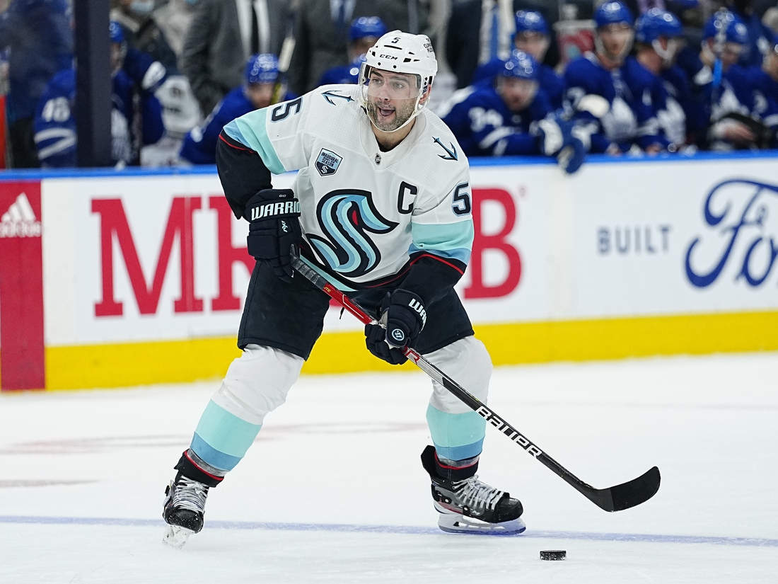 Mar 8, 2022; Toronto, Ontario, CAN; Seattle Kraken defenseman Mark Giordano (5) goes to pass the puck against the Toronto Maple Leafs at Scotiabank Arena. Mandatory Credit: John E. Sokolowski-USA TODAY Sports