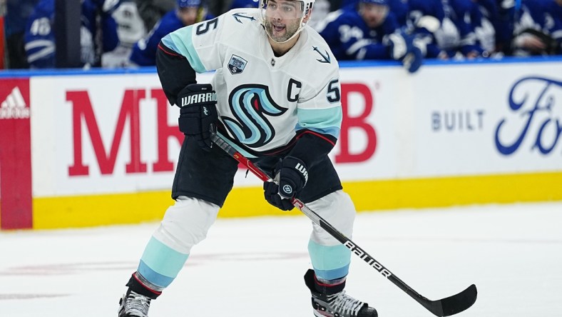 Mar 8, 2022; Toronto, Ontario, CAN; Seattle Kraken defenseman Mark Giordano (5) goes to pass the puck against the Toronto Maple Leafs at Scotiabank Arena. Mandatory Credit: John E. Sokolowski-USA TODAY Sports