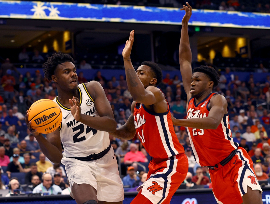 Mar 9, 2022; Tampa, FL, USA; Missouri Tigers forward Kobe Brown (24) drives to the basket as Mississippi Rebels guard Tye Fagan (14) and Mississippi Rebels forward Sammy Hunter (23) defend during the first half at Amalie Arena. Mandatory Credit: Kim Klement-USA TODAY Sports