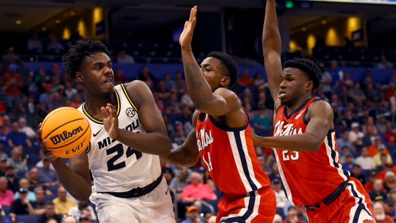 Mar 9, 2022; Tampa, FL, USA; Missouri Tigers forward Kobe Brown (24) drives to the basket as Mississippi Rebels guard Tye Fagan (14) and Mississippi Rebels forward Sammy Hunter (23) defend during the first half at Amalie Arena. Mandatory Credit: Kim Klement-USA TODAY Sports