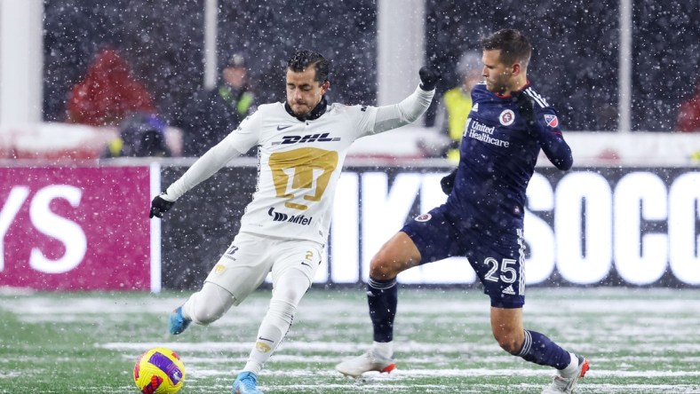 Mar 9, 2022; Foxborough, Massachusetts, USA; Pumas UNAM defender Alan Mozo (2) passes the ball defended by New England Revolution midfielder Arnor Traustason (25) during the first half at Gillette Stadium. Mandatory Credit: Paul Rutherford-USA TODAY Sports