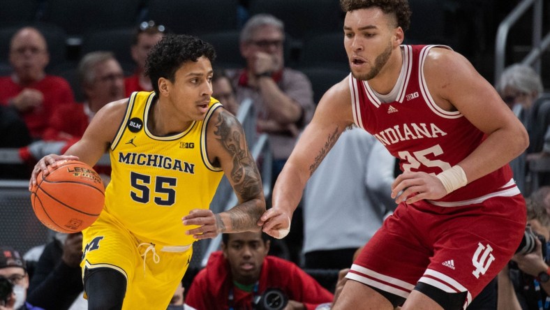 Mar 10, 2022; Indianapolis, IN, USA; Michigan Wolverines guard Eli Brooks (55) dribbles the ball while Indiana Hoosiers forward Race Thompson (25) defends in the first half at Gainbridge Fieldhouse. Mandatory Credit: Trevor Ruszkowski-USA TODAY Sports