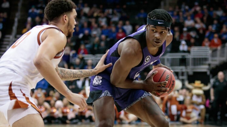 Mar 10, 2022; Kansas City, MO, USA; TCU Horned Frogs forward Emanuel Miller (2) looks to get around Texas Longhorns forward Timmy Allen (0) during the second half at T-Mobile Center. Mandatory Credit: William Purnell-USA TODAY Sports