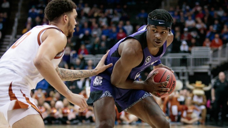 Mar 10, 2022; Kansas City, MO, USA; TCU Horned Frogs forward Emanuel Miller (2) looks to get around Texas Longhorns forward Timmy Allen (0) during the second half at T-Mobile Center. Mandatory Credit: William Purnell-USA TODAY Sports