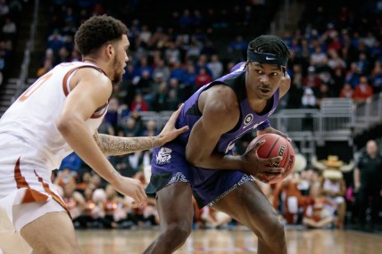 Mar 10, 2022; Kansas City, MO, USA; TCU Horned Frogs forward Emanuel Miller (2) looks to get around Texas Longhorns forward Timmy Allen (0) during the second half at T-Mobile Center. Mandatory Credit: William Purnell-USA TODAY Sports