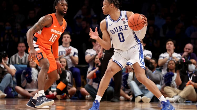 Mar 10, 2022; Brooklyn, NY, USA; Duke Blue Devils forward Wendell Moore Jr. (0) controls the ball against Syracuse Orange guard Symir Torrence (10) during the second half at Barclays Center. Mandatory Credit: Brad Penner-USA TODAY Sports