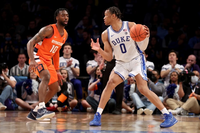 Mar 10, 2022; Brooklyn, NY, USA; Duke Blue Devils forward Wendell Moore Jr. (0) controls the ball against Syracuse Orange guard Symir Torrence (10) during the second half at Barclays Center. Mandatory Credit: Brad Penner-USA TODAY Sports