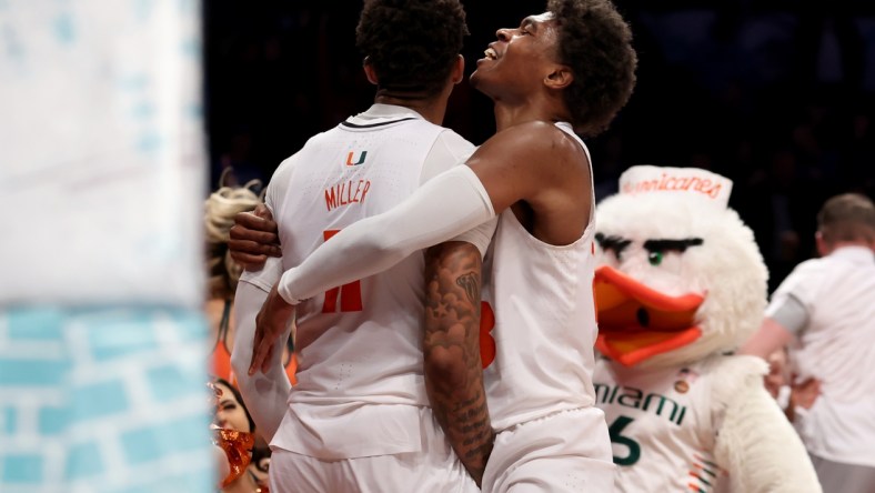 Mar 10, 2022; Brooklyn, NY, USA; Miami Hurricanes guard Jordan Miller (11) celebrates his buzzer beater layup with guard Charlie Moore (3) to beat the Boston College Eagles during overtime at Barclays Center. Mandatory Credit: Brad Penner-USA TODAY Sports