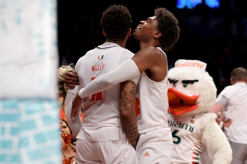 Mar 10, 2022; Brooklyn, NY, USA; Miami Hurricanes guard Jordan Miller (11) celebrates his buzzer beater layup with guard Charlie Moore (3) to beat the Boston College Eagles during overtime at Barclays Center. Mandatory Credit: Brad Penner-USA TODAY Sports