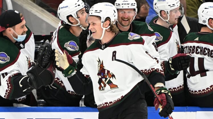 Mar 10, 2022; Toronto, Ontario, CAN; Arizona Coyotes defenseman Jakob Chychrun (6) celebrates with team mates at the bench after scoring against the Toronto Maple Leafs in the first period at Scotiabank Arena. Mandatory Credit: Dan Hamilton-USA TODAY Sports