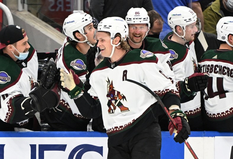 Mar 10, 2022; Toronto, Ontario, CAN; Arizona Coyotes defenseman Jakob Chychrun (6) celebrates with team mates at the bench after scoring against the Toronto Maple Leafs in the first period at Scotiabank Arena. Mandatory Credit: Dan Hamilton-USA TODAY Sports